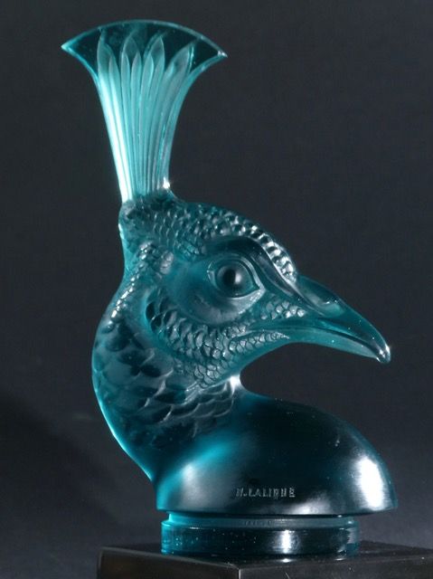 This fantastic Tête de Paon (Peacocks' Head) is in a vivid turquoise full colour finish, correctly intaglio signed 'R. Lalique, France'. Extremely rare to find any colour pieces! It is mounted onto a Lalique factory produced black glass base which is also signed etched 'Lalique France'. A superb investment connoisseur collector's piece at £75,950. This was introduced onto the market on the 3rd of February 1928 and listed in the official Lalique catalogue as No.1140. This piece is offered for sale from us in superb original condition, of which a full condition report can be sent to any seriously interested parties. This was located in Paris from a very well known collection. Very few turn up or are seen outside museum collections. A superb investment as this is a once-in-a-lifetime opportunity to acquire this almost unique piece of Lalique history!